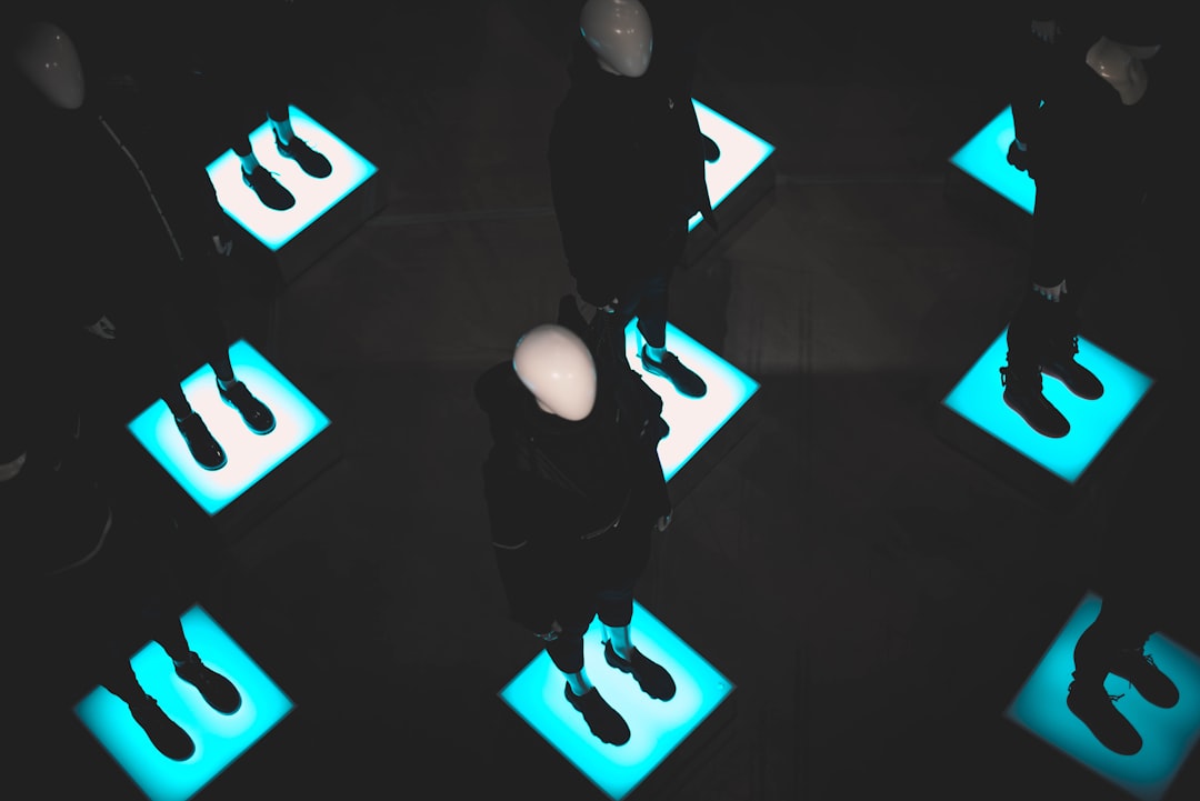 mannequins standing on lighted platforms — Photo by Victória Kubiaki on Unsplash