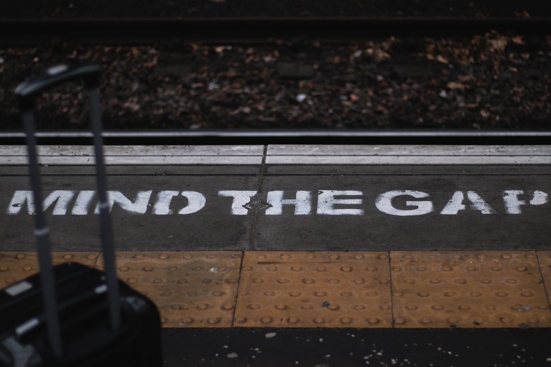 a piece of luggage sitting on the side of a train track — Photo by Louis Corallo on Unsplash
