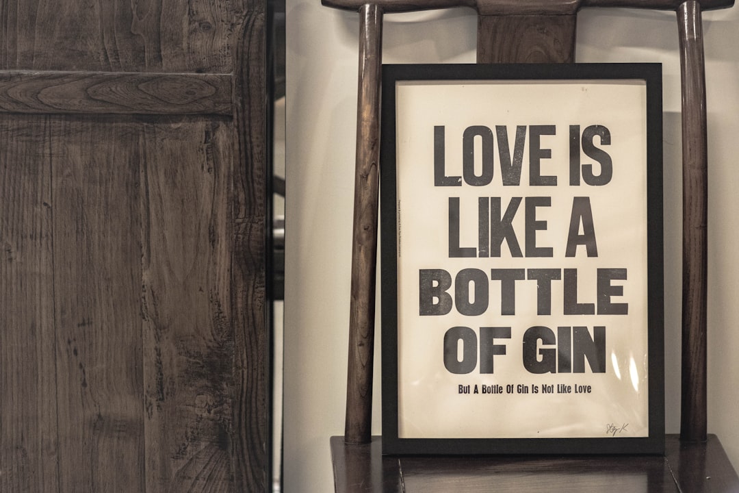 love is like a bottle of gin signage — Photo by Jason W on Unsplash