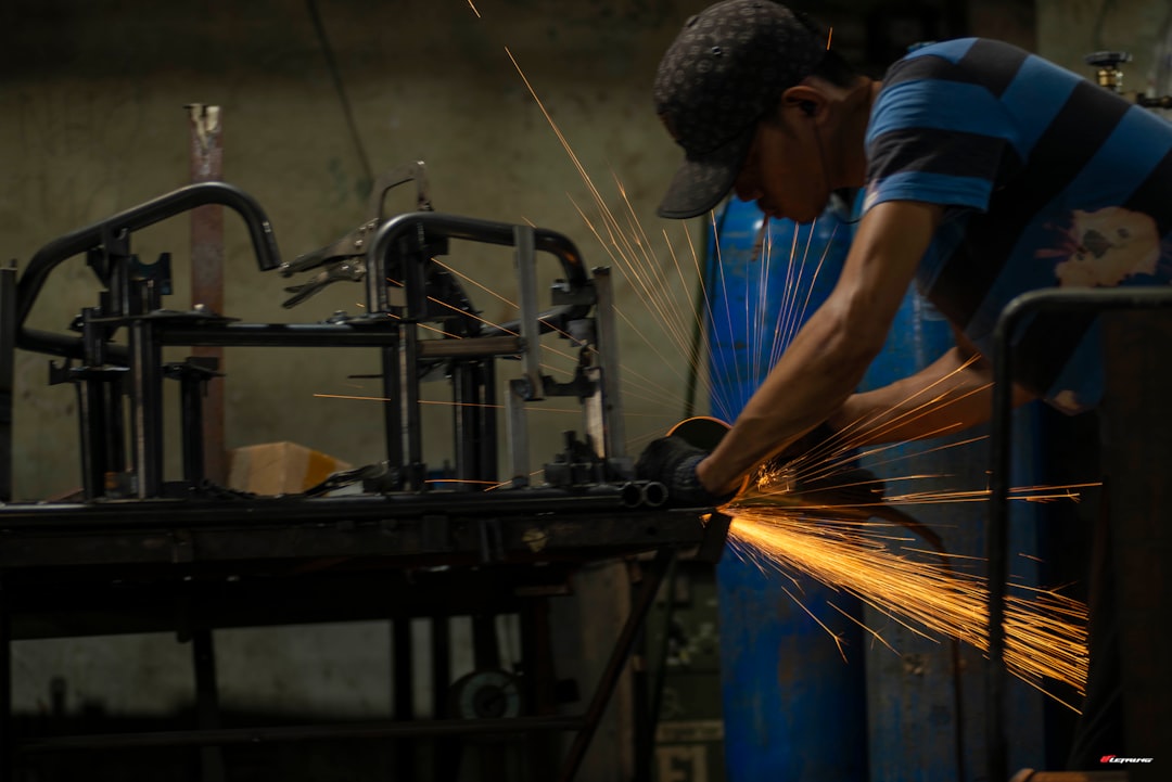 a man working on a machine in a factory — Photo by Le Trung on Unsplash