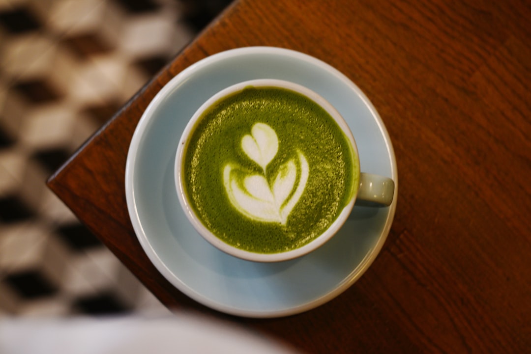 A cup of matcha latte with latte art — Photo by Liana S on Unsplash