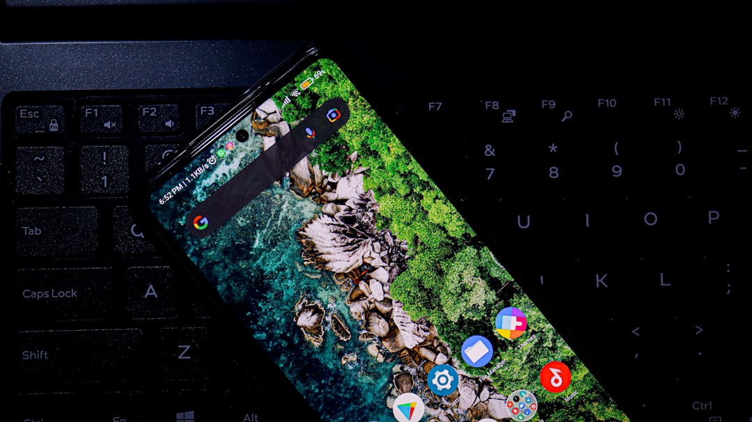 a cell phone sitting on top of a computer keyboard — Photo by Topique SL on Unsplash