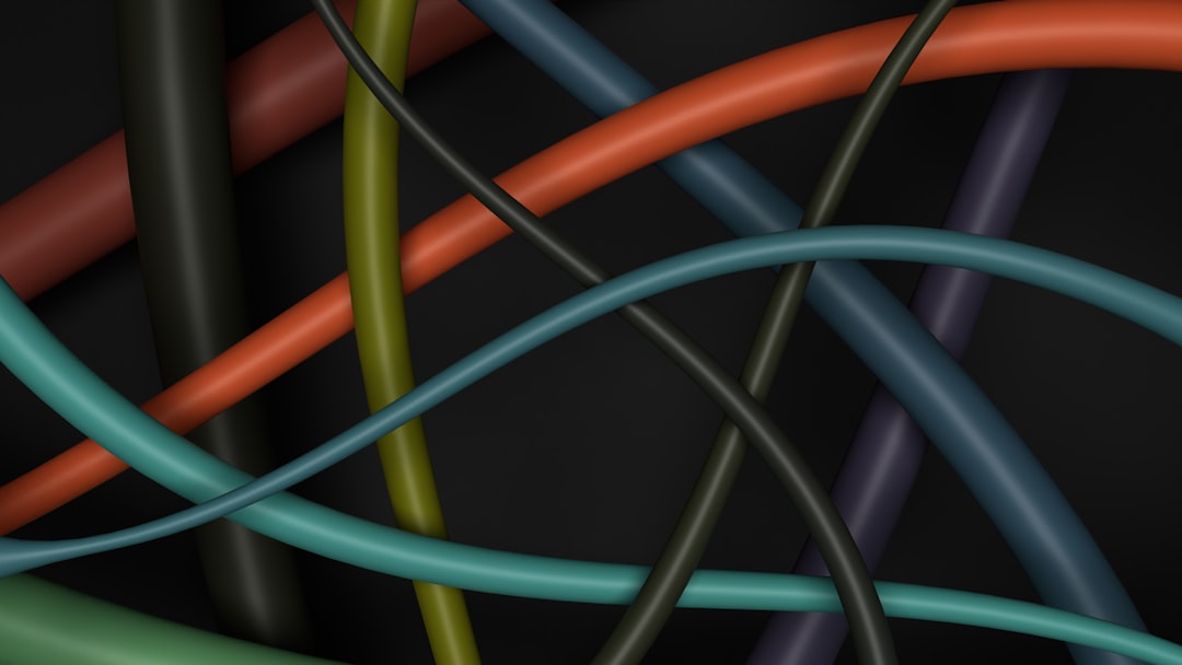 a close up of many different colored wires — Photo by Sufyan on Unsplash