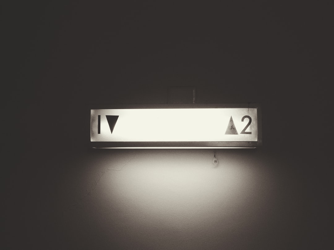 gray framed 1 and 2 elevator signage — Photo by Possessed Photography on Unsplash