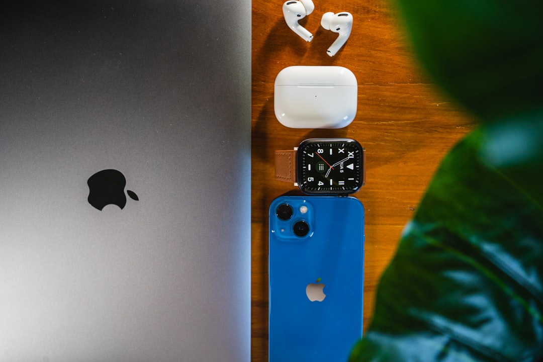 an apple laptop, headphones, and earbuds on a table — Photo by Douglas Mendes on Unsplash