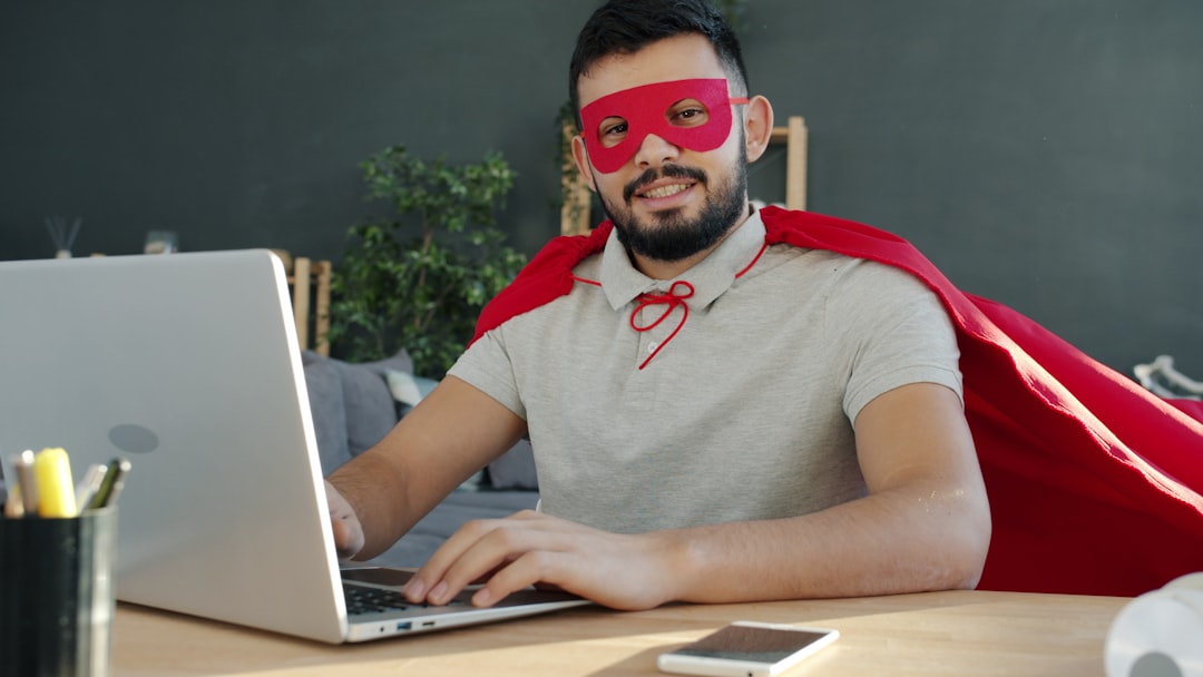 Man in superhero costume working on laptop — Photo by Vitaly Gariev on Unsplash