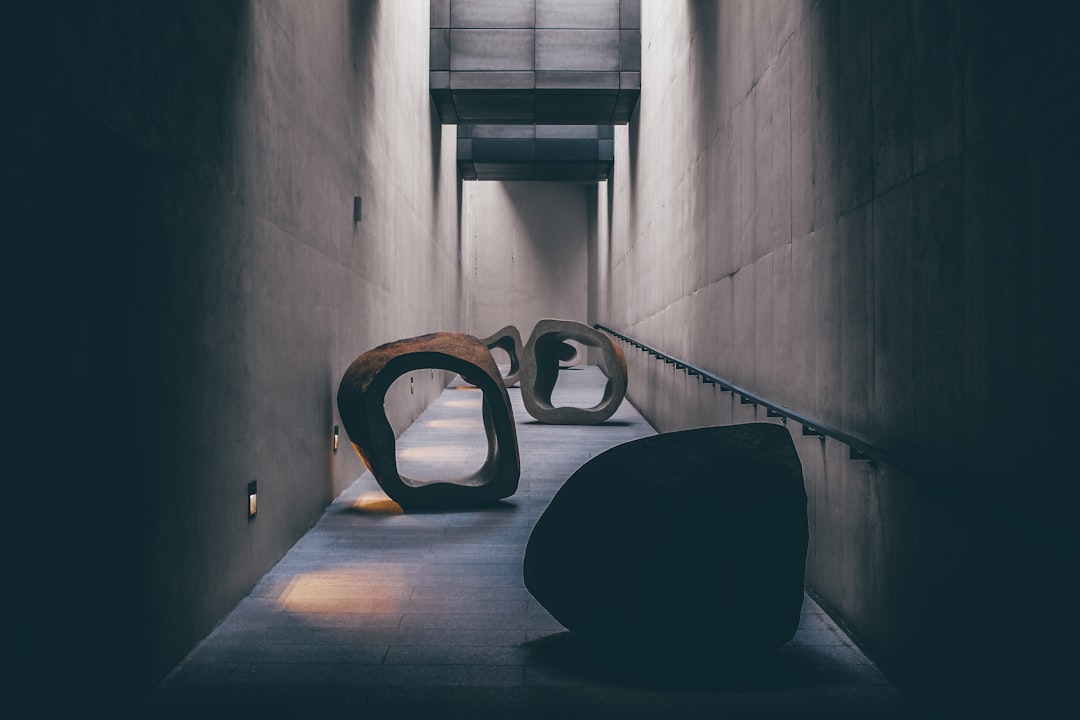 a couple of large sculptures sitting on top of a cement floor — Photo by Andrea De Santis on Unsplash